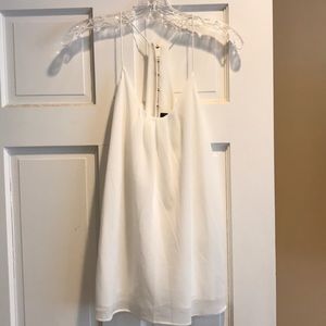 White top with gold buttons on the back